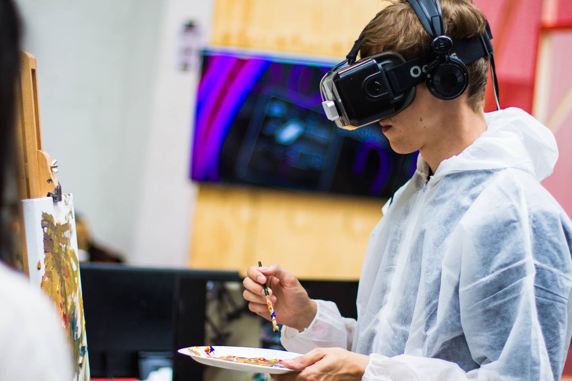 Boy painting with VR glasses on