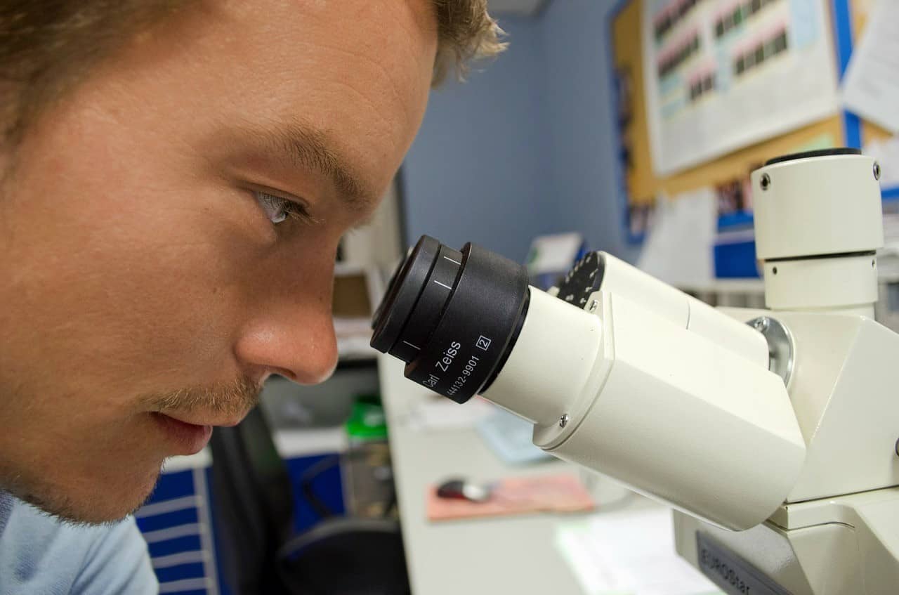 A man looking into a microscope